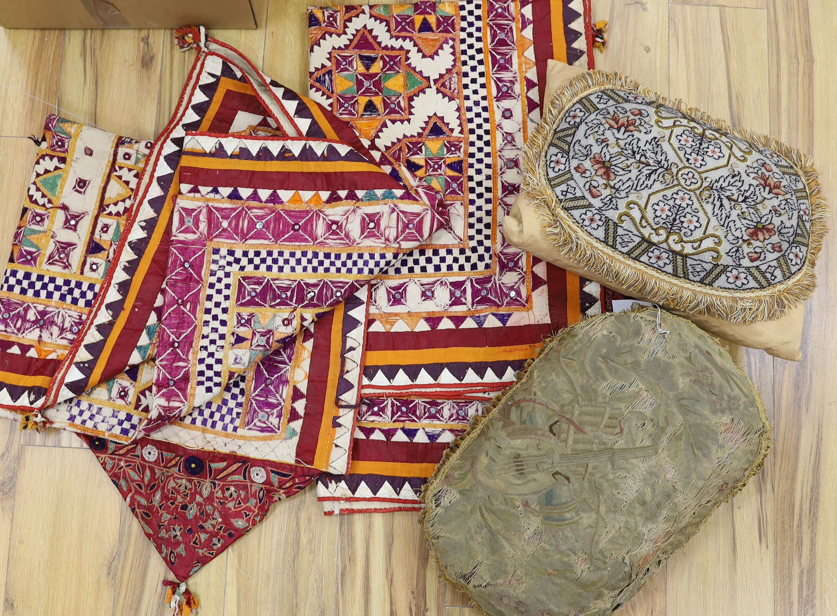 An Indian embroidered cover and cushions